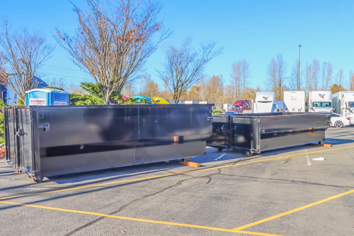 Professional dumpster rental service with roll-off container on residential driveway in Kihei